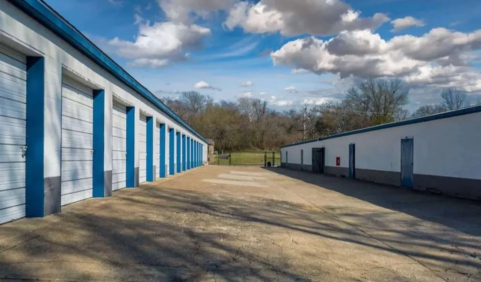 Gated self-storage facility entrance with keypad access and wide driveway